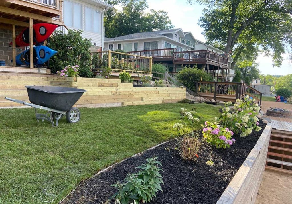 Fertilized lawn with a retaining wall and barrier garden